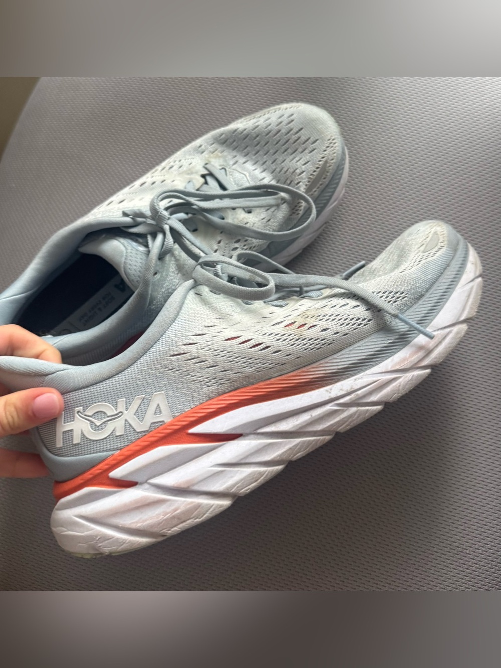 Hoka Women’s Light Gray Running Shoes with Orange Accent